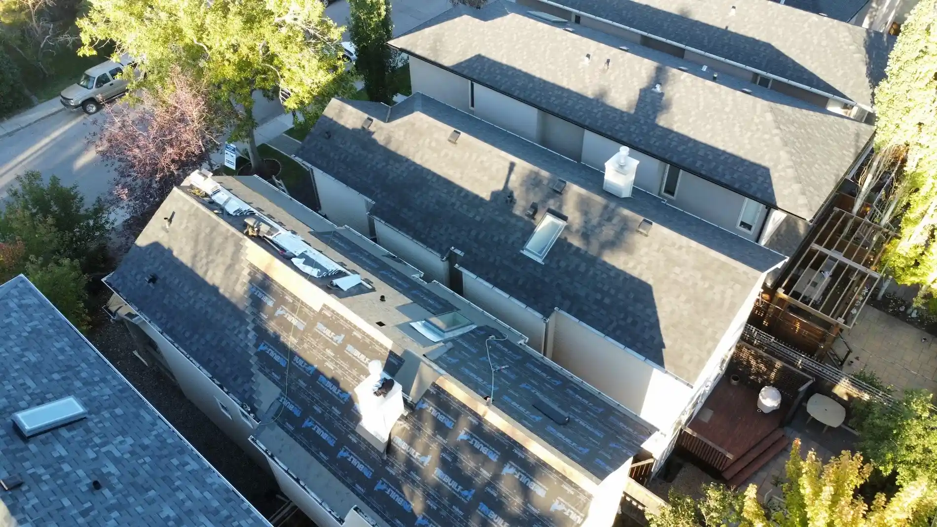 Aerial drone view of asphalt roof replacement in progress by Right To The Peak